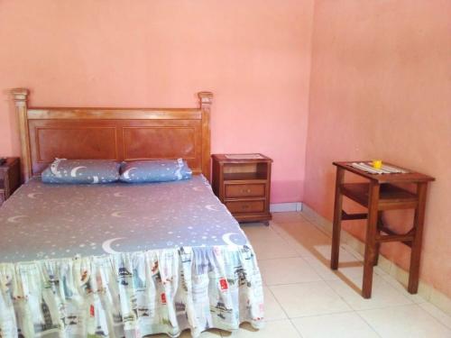 a bedroom with a bed and a side table at La Ponderosa in Asunción