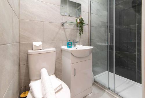 a bathroom with a toilet and a sink and a shower at Kingsway House in Coventry