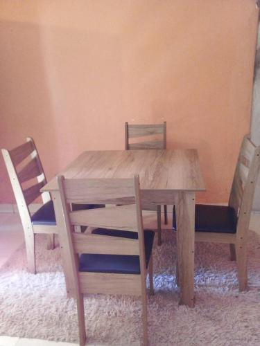 a wooden table with two chairs and a wooden table and chairs at La Ponderosa in Asunción