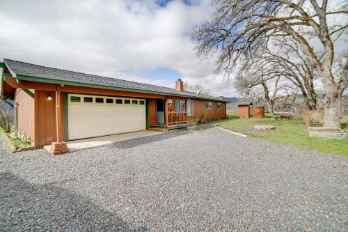a house with a garage and a driveway at 30-Acre Witter Springs Ranch with Barn and Views! in Upper Lake