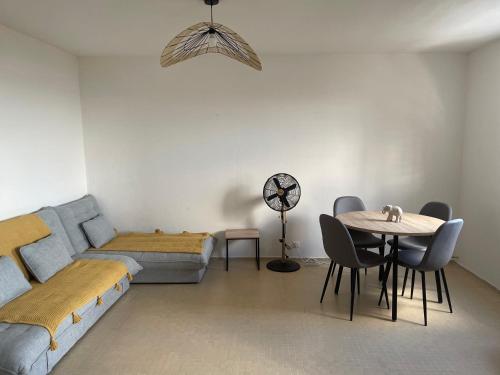 a living room with a couch and a table at Maison Bel bonjou in Le Marin