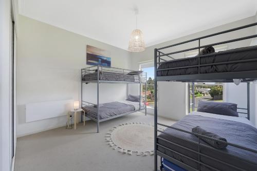 a bedroom with two bunk beds and a window at Hillside - Family Orientated Holiday Home in Warrnambool