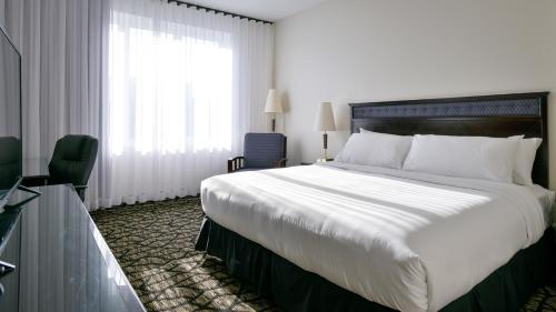 a hotel room with a large bed and a window at Empire Suites in Montréal