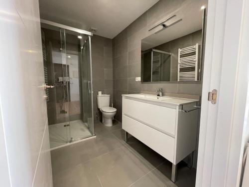 a bathroom with a shower and a sink and a toilet at IBAIA by Smiling Rentals in Hondarribia