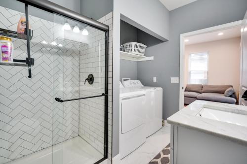 a bathroom with a shower and a washer and dryer at Columbus Vacation Rental about 4 Mi to Downtown! in Columbus