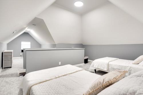 a white room with two beds and a staircase at Columbus Vacation Rental about 4 Mi to Downtown! in Columbus