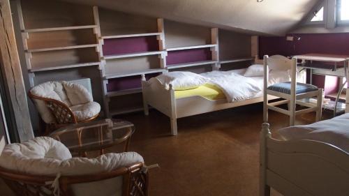 a room with two bunk beds and chairs at Flat in Central Poznan in Poznań