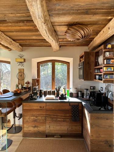 a kitchen with wooden ceilings and a counter top at Private Luxury Spa & Silence Retreat with Spectacular View over the Lake Maggiore in Stresa