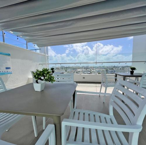 a table and chairs on a balcony with a view at Azure Lofts & Pool in San Andrés