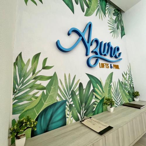 a sign on a wall with plants on it at Azure Lofts & Pool in San Andrés