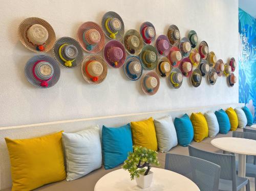 a row of pillows and hats hanging on a wall at Azure Lofts & Pool in San Andrés
