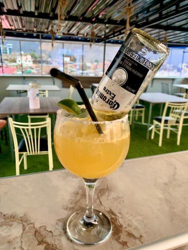 a drink on a table with a bottle of beer at Arum Qurpawasi Hospedaje in Cabanaconde