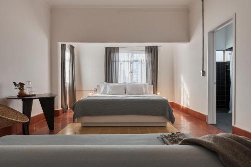 a bedroom with a large bed and a window at Posada Independencia in Oaxaca City