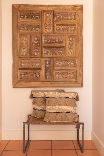 a pile of mats on a bench in a room at Rota VMF - Alcobaça in Cruz da Légua