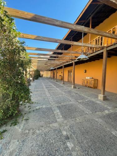 an empty courtyard of a building with orange walls at Glamping Miraflores in Vicuña