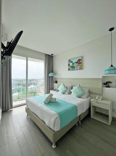 a bedroom with a large bed and a large window at Azure Lofts & Pool in San Andrés
