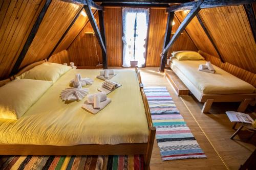 a room with two beds with towels and dolls on them at Holiday house with a parking space Sabljak Selo, Gorski kotar - 20580 in Ogulin