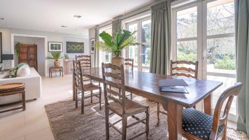 a dining room with a wooden table and chairs at Sumner Surf Break Apt 1 in Christchurch