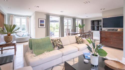 a living room with a white couch and a table at Sumner Surf Break Apt 1 in Christchurch
