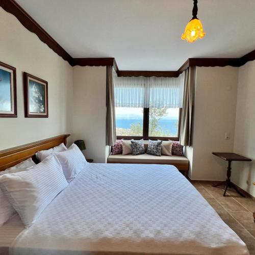 a bedroom with a large bed and a couch at KAZDAĞLARI ZEYTUNİHAN BUTİK OTEL in Edremit