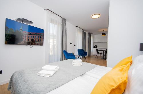 a bedroom with a bed with two towels on it at InPoint Apartments G15 near Old Town & Kazimierz District & Optional Paid Parking in Kraków