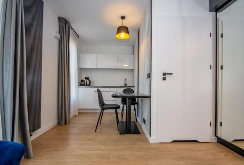 a small apartment with a table and a kitchen at InPoint Apartments G15 near Old Town & Kazimierz District & Optional Paid Parking in Kraków