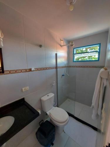 a bathroom with a toilet and a shower and a sink at Pousada Santo Aleixo in Porto De Galinhas