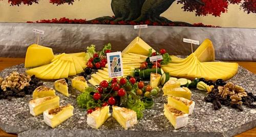 a display of cheese and fruit on a table at Enchanted Galapagos Lodge in Puerto Ayora