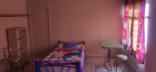 ein kleines Zimmer mit einem kleinen Bett und einem Hocker in der Unterkunft La Providencia in Orizaba