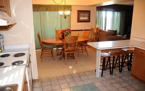 a kitchen and living room with a table and chairs at Seven Springs 2 Bedroom Standard Condo, Sleeps 10! condo in Champion