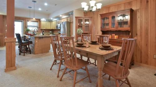 a large kitchen with a wooden table and chairs at Seven Springs Woodridge 3 Bedroom Premium Condo, Sleeps 7! condo in Champion