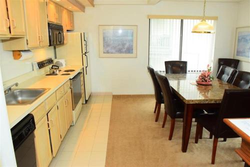 a kitchen with a table and a dining room at Seven Springs Stoneridge 3 Bedroom Standard Condo, Mountain Views! condo in Champion