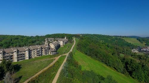 an aerial view of a building on a hill at Seven Springs Stoneridge 3 Bedroom Standard Condo, Mountain Views! condo in Champion