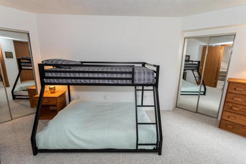 a bunk bed in a room with a mirror at Seven Springs Meadowridge 2 Bedroom Standard Condo with Loft, Mountain Views! condo in Champion