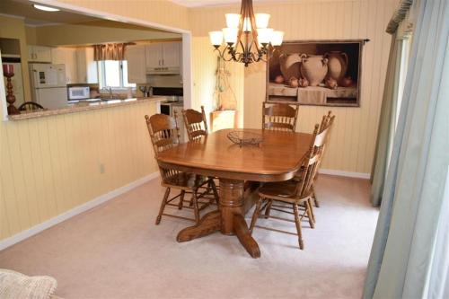 a dining room table and chairs in a kitchen at Seven Springs 2 Bedroom Standard Condo with Private Deck! condo in Champion