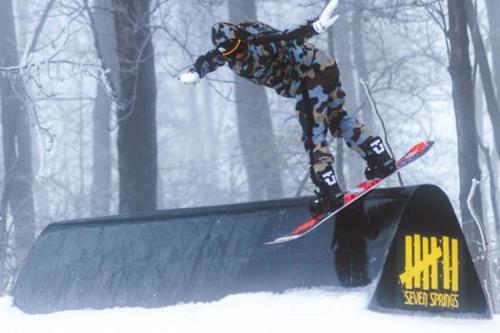 a person on a snowboard doing a trick on a ramp at Seven Springs 2 Bedroom Standard Condo with Private Deck! condo in Champion