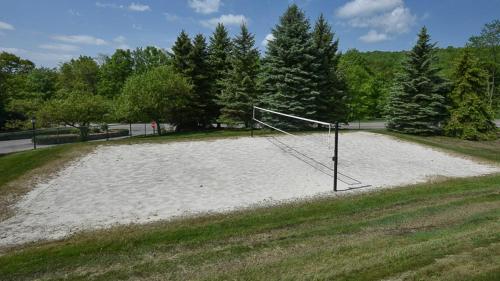 a volleyball field with a net in the sand at Seven Springs Woodridge 4 Bedroom Premium Condo, Deck with Mountain Views condo in Champion