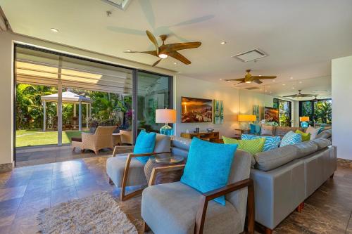 a living room with a couch and chairs and a ceiling fan at Andaz Villa 810 villa in Wailea