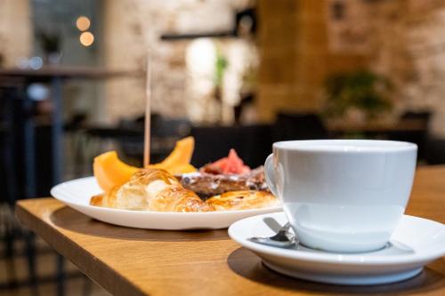 a plate of food and a cup of coffee on a table at Palazzo Gilistro in Siracusa