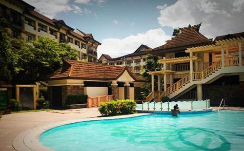 a large swimming pool in front of a building at One Oasis Condominium in Davao City