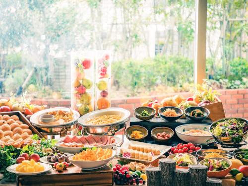 a buffet with many bowls of food on a table at Hotel Hanshin Osaka in Osaka