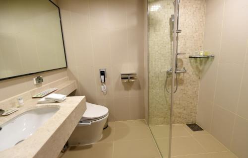 a bathroom with a shower and a sink and a toilet at Wirye Militopia Hotel By Marine in Seongnam