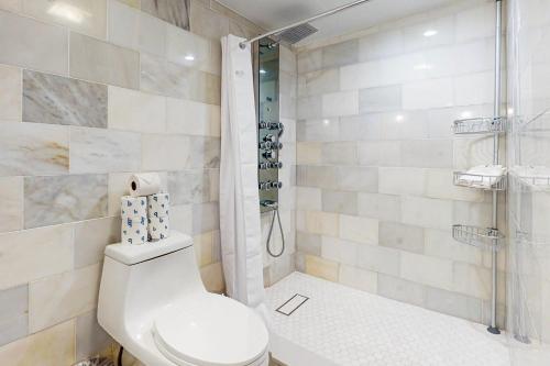 a bathroom with a toilet and a shower at Julia Whitehead Guest Suites in Key West