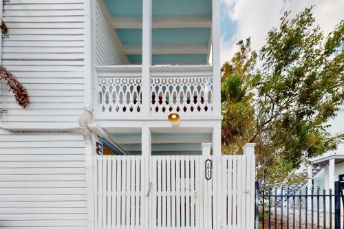 a white fence in front of a white house at Julia Whitehead Guest Suites in Key West