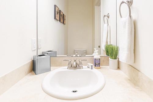 a white bathroom with a sink and a mirror at The Aerie of Eagle in Eagle