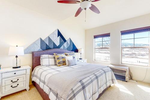 a bedroom with a bed and a ceiling fan at The Aerie of Eagle in Eagle