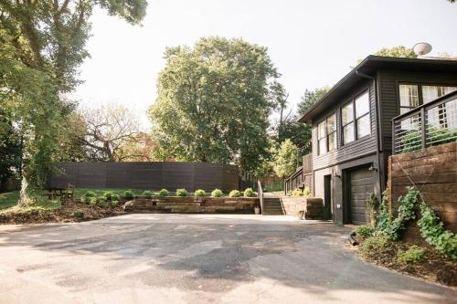 a house with a driveway in front of it at Ode to the '70's creative private home with pool in Honey Brook