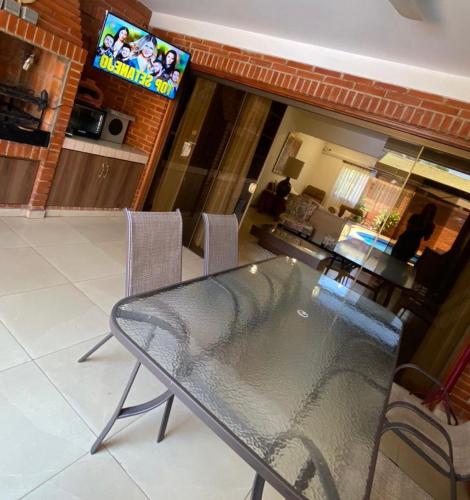 a glass table and chairs in a living room at Casa hotel in Encarnación