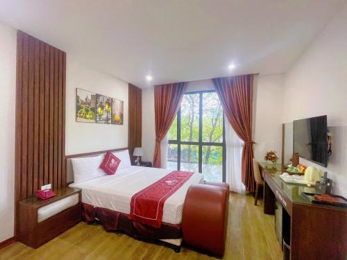 a hotel room with a bed and a window at Rosy Motel Trung Yên in Hanoi