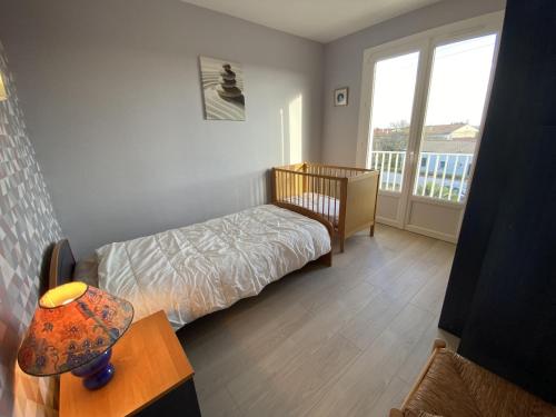 une petite chambre avec un lit et un balcon dans l'établissement Maison Familiale à Fouras : Plages, Jardin, Garage - FR-1-709-38, à Fouras